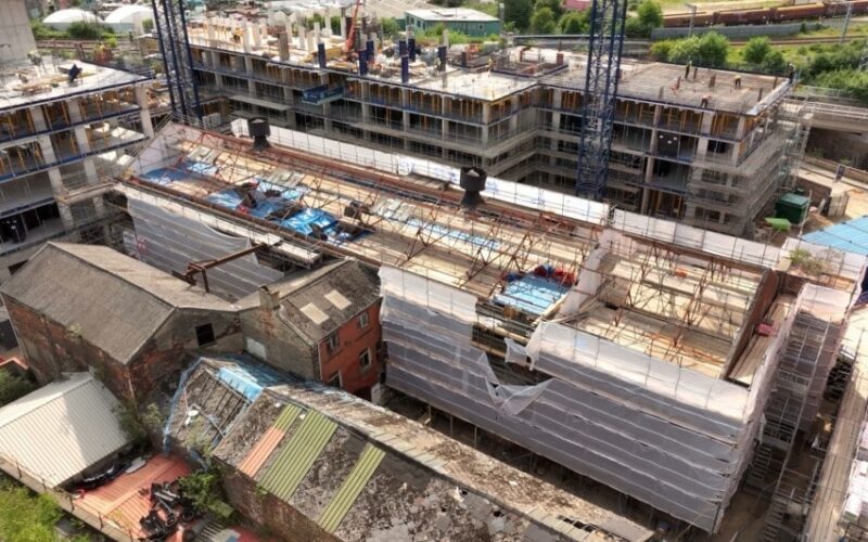 External view of Midland Mills prior to restoration, showing aged brickwork and original roof structure.