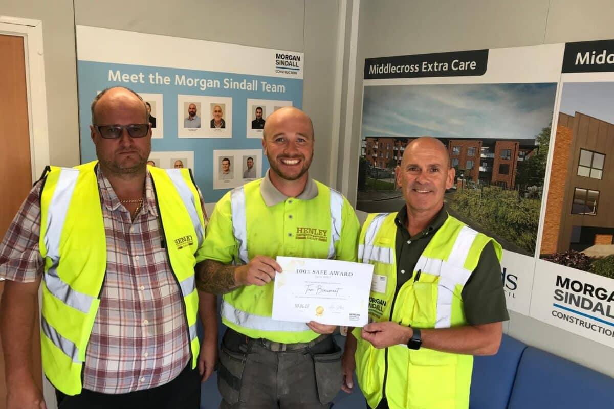 Tom Beaumont receiving Employee of the Month award from Morgan Sindall on site at Middlecross Care Home in Leeds