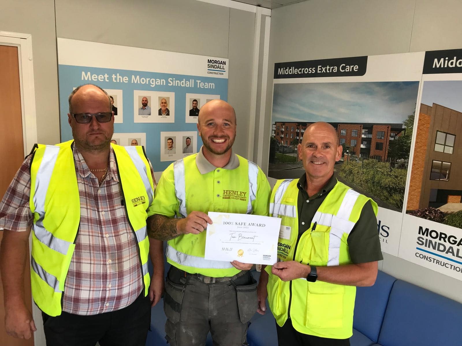 Tom Beaumont receiving Employee of the Month award from Morgan Sindall on site at Middlecross Care Home in Leeds