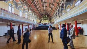 Guided tour group exploring the restored music hall at West Bromwich Town Hall